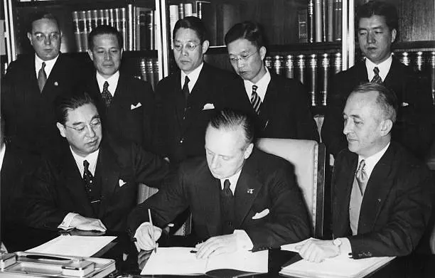 Joachim von Ribbentrop signs the pact beside the Japanese ambassador Kintomo Mushanokōji, Berlin, 25 November 1936.