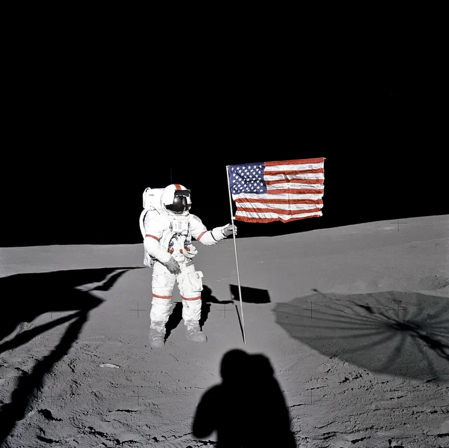 Alan Shepard beside the US flag in the Fra Mauro highlands during the first Apollo 14 moonwalk, 5 February 1971.