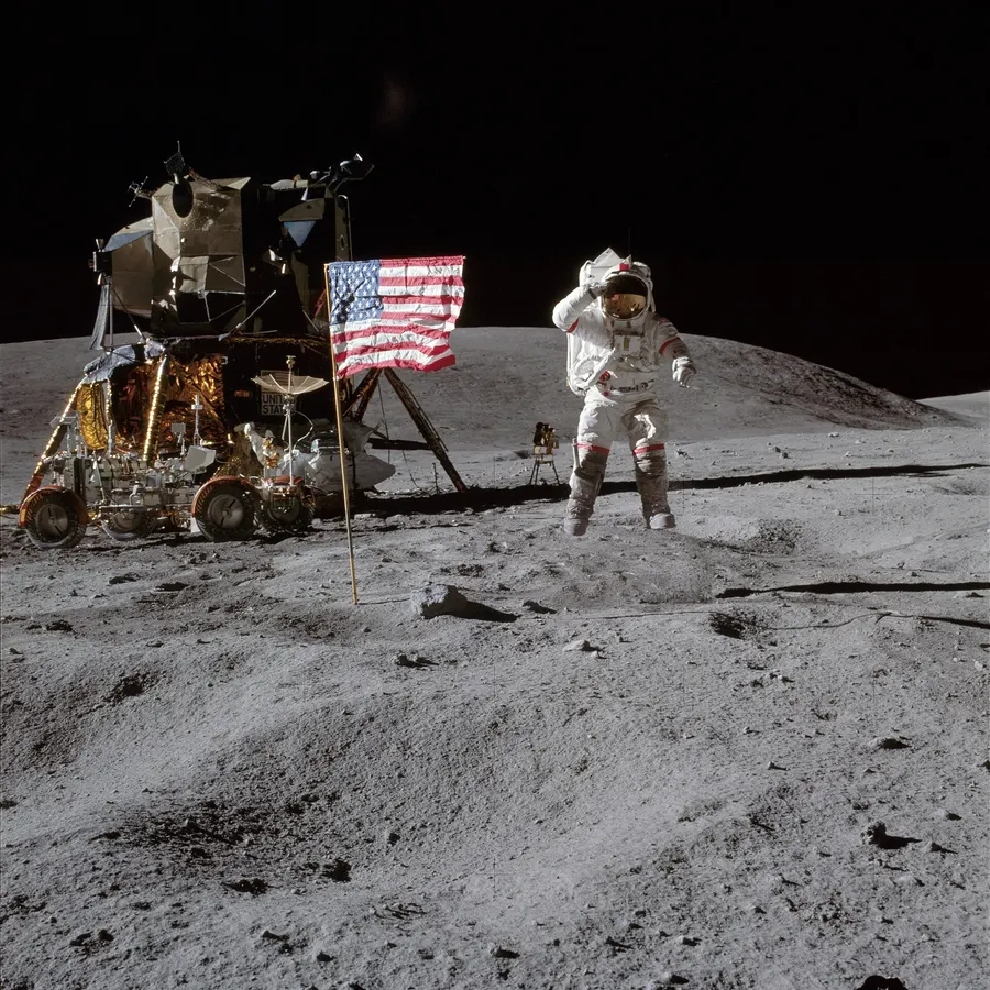 John Young leaps beside the flag and the lunar module Orion, photographed by Charles Duke during Apollo 16.