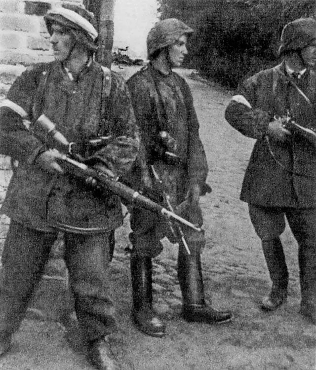 Home Army soldiers of the Zośka battalion, in captured German uniforms and with captured weapons, on 5 August 1944