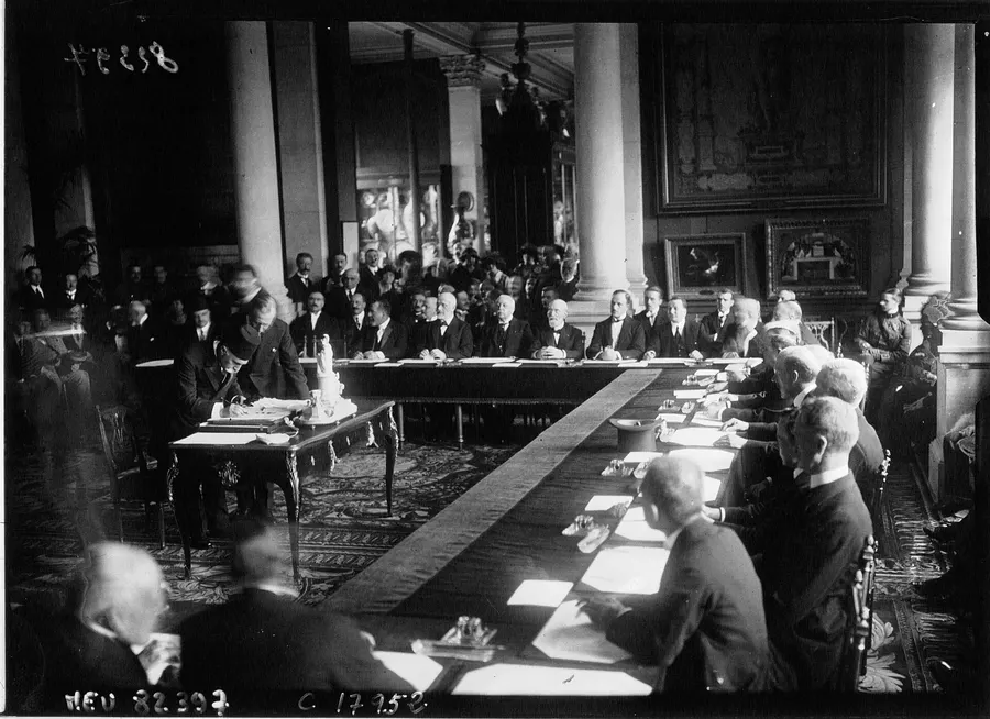 The Ottoman delegation signs the Treaty of Sèvres on 10 August 1920, in a press photograph by the Agence Meurisse
