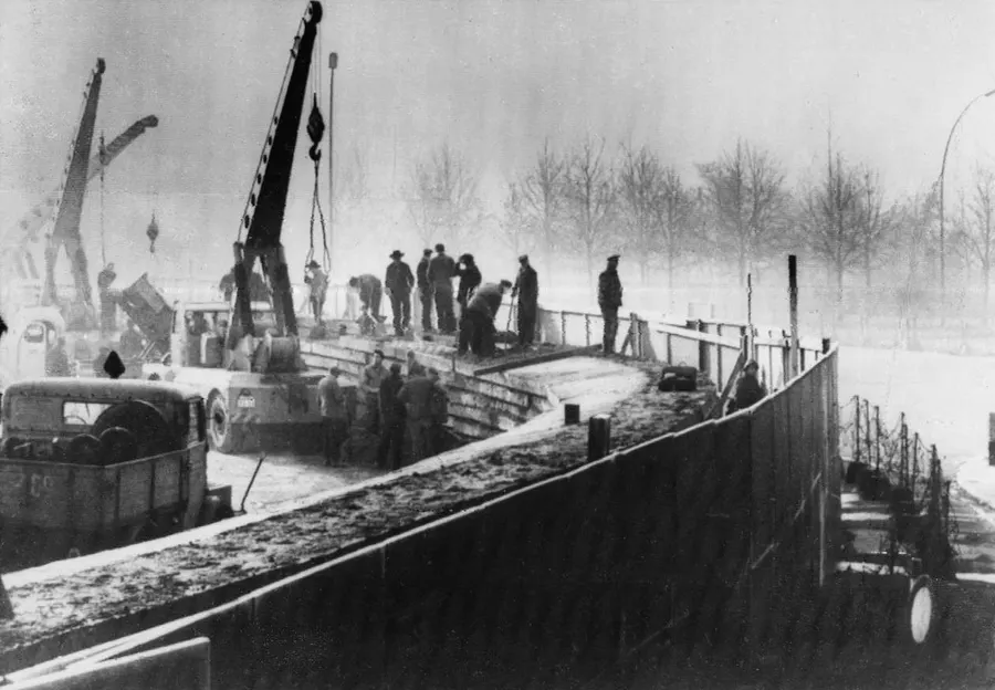 East German workers use cranes to strengthen the new wall in Berlin, 20 November 1961