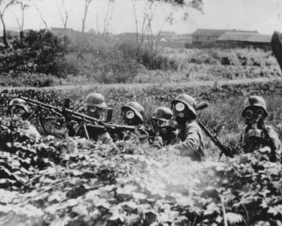 Chinese soldiers in gas masks man a machine gun outside Shanghai in 1937