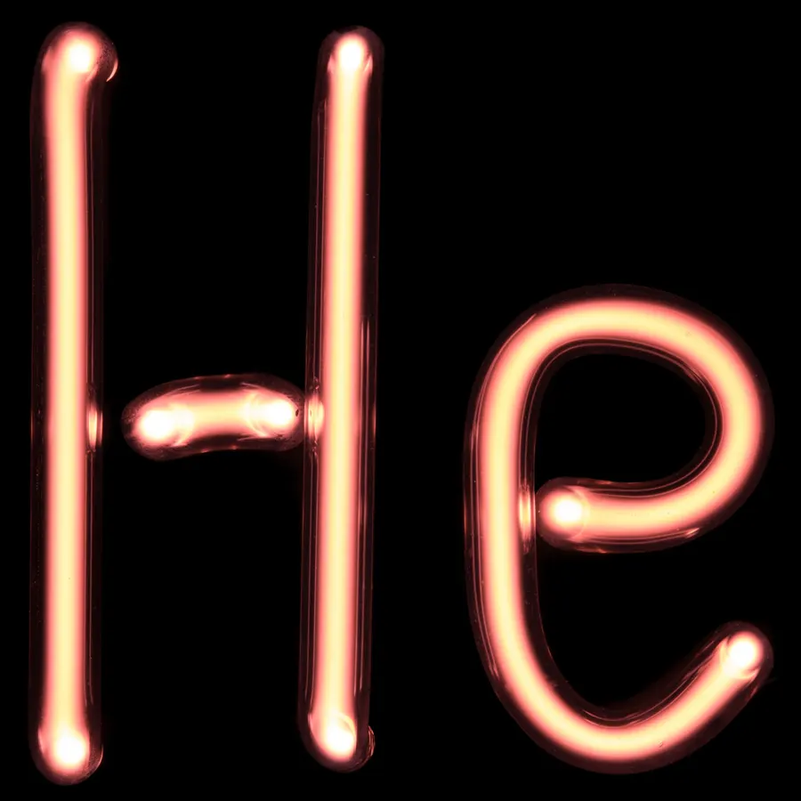 A glass tube of helium glowing as an electric current passes through it