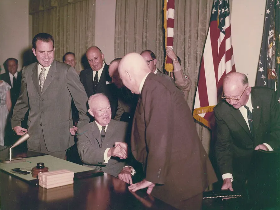 President Dwight D. Eisenhower, seated, at the signing of the proclamation admitting Hawaii as the 50th state, 21 August 1959