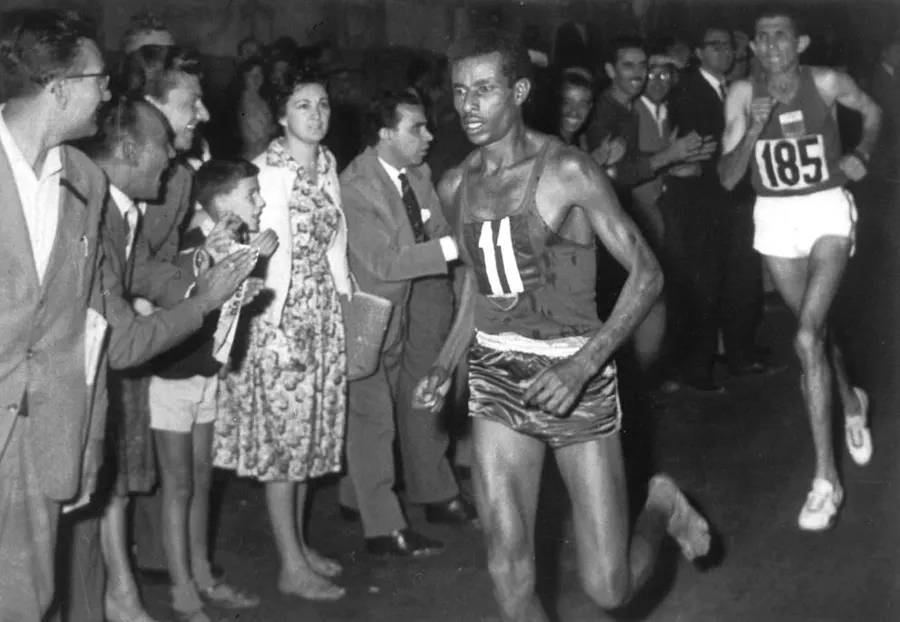 Abebe Bikila runs barefoot ahead of Rhadi Ben Abdesselam near the end of the marathon at the 1960 Rome Olympics