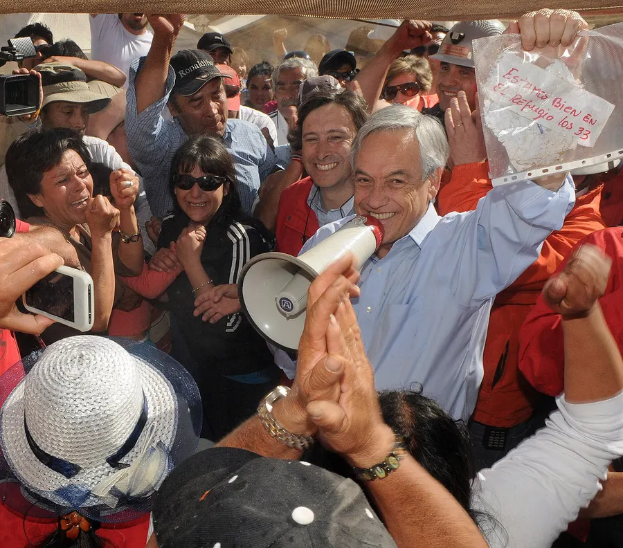 President Sebastián Piñera of Chile holds up the note from the trapped miners, 'We are well in the shelter, the 33'