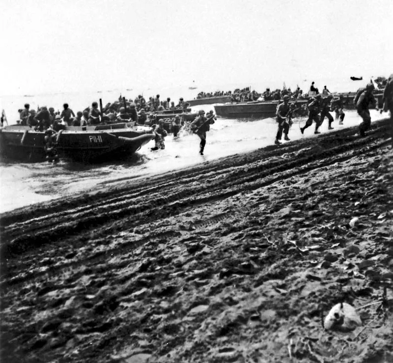 US Marines of the 1st Division come ashore on Guadalcanal from their landing craft on 7 August 1942