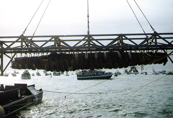 The H. L. Hunley, slung beneath its steel recovery frame, is lifted from the sea off Charleston on 8 August 2000