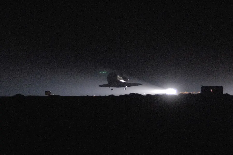 Space Shuttle Discovery glides in to a pre-dawn landing at Edwards Air Force Base, California, on 9 August 2005