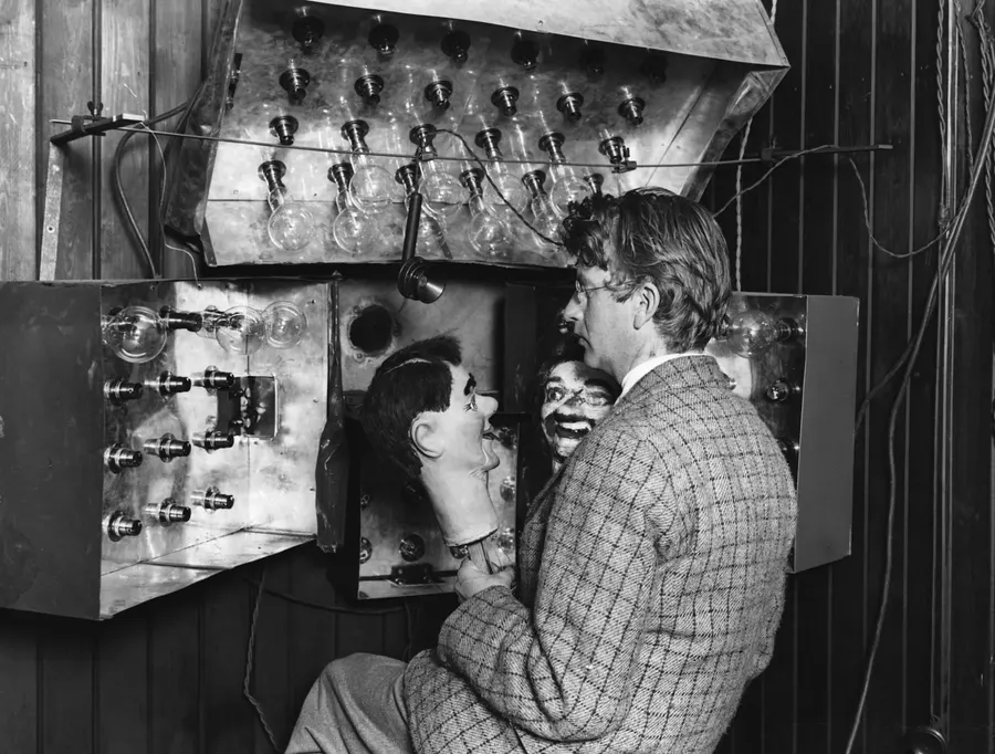 John Logie Baird with his early television apparatus and the ventriloquist's dummy he used as a subject.