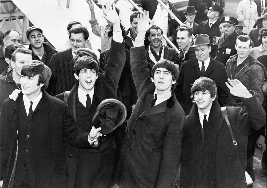 The Beatles arrive at Kennedy Airport in New York, February 1964.