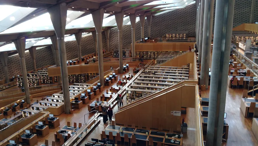 The main reading room of the Bibliotheca Alexandrina, under its tilted glass roof.