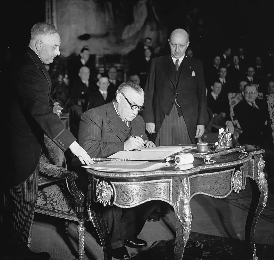 The British foreign secretary Ernest Bevin signs the Brussels Treaty, 17 March 1948.