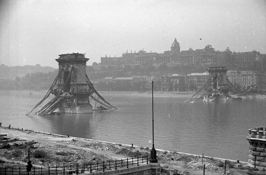The wrecked Chain Bridge over the Danube and the ruined Royal Palace on Castle Hill, Budapest, 1945.