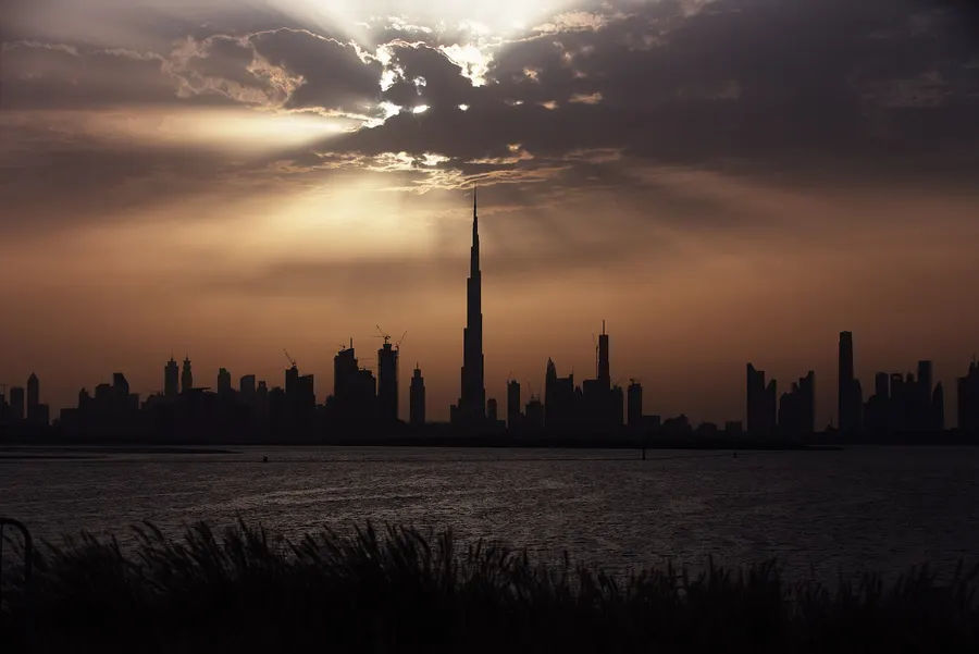 The Burj Khalifa rising above the Dubai skyline at sunset.