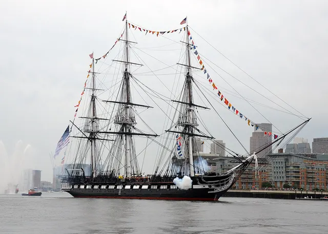 USS Constitution dressed with flags in Boston harbour.
