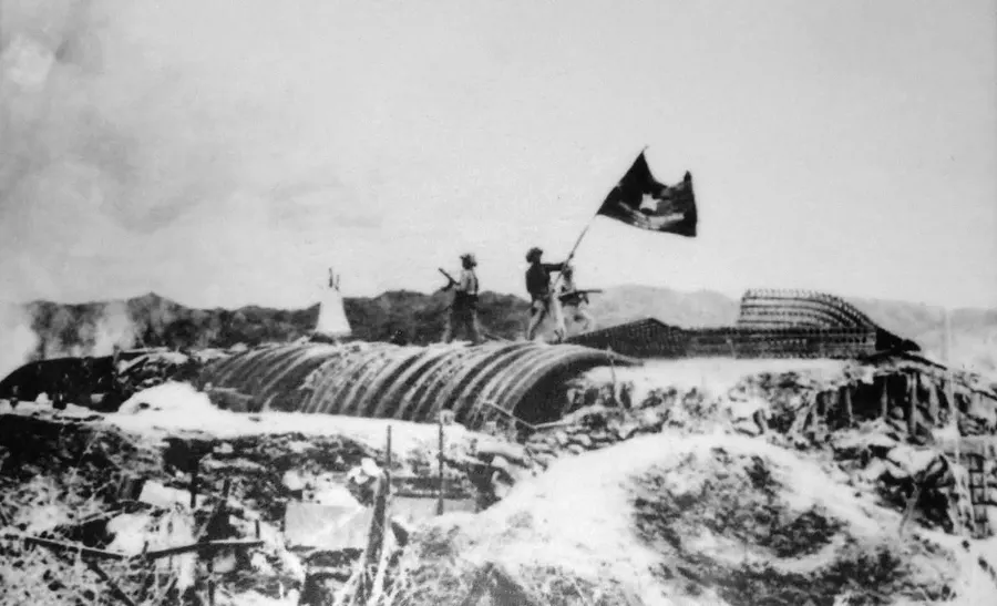 Viet Minh soldiers raise their flag over the captured French command bunker at Dien Bien Phu, 1954.