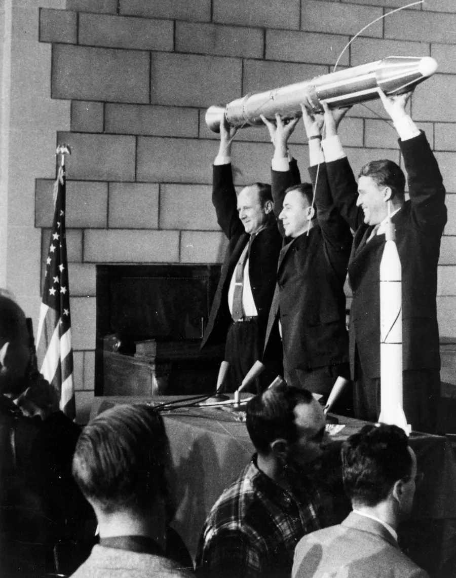William Pickering, James Van Allen and Wernher von Braun hold up a model of Explorer 1 at the press conference after the launch.