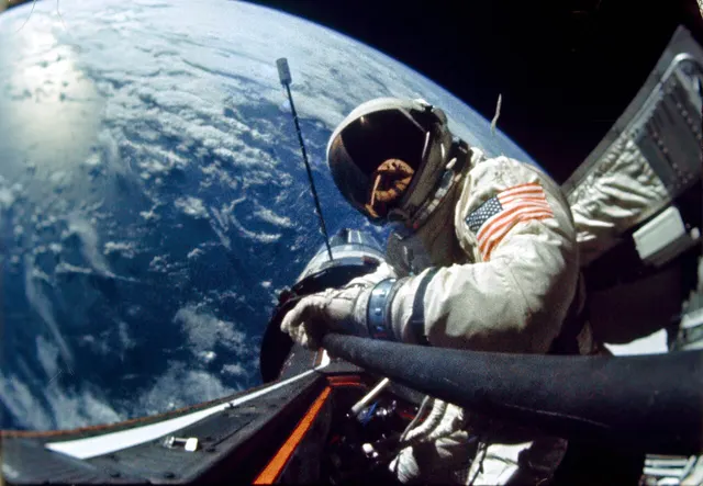 Buzz Aldrin standing in the open hatch of Gemini 12 on 12 November 1966, photographed by Jim Lovell.