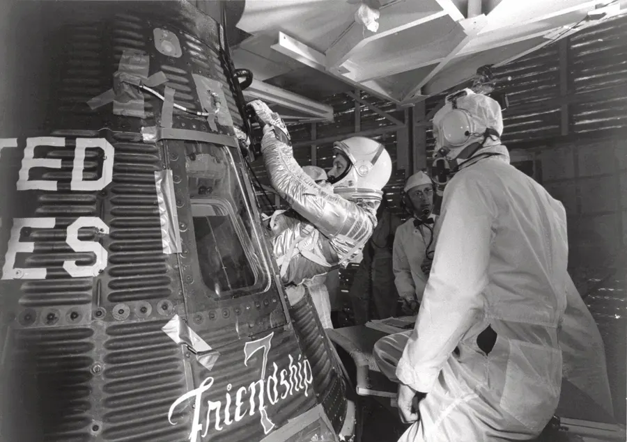 John Glenn climbs into Friendship 7 before launch on 20 February 1962.