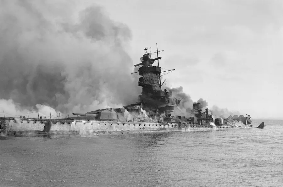 The Admiral Graf Spee in flames after being scuttled in the River Plate estuary, 17 December 1939.