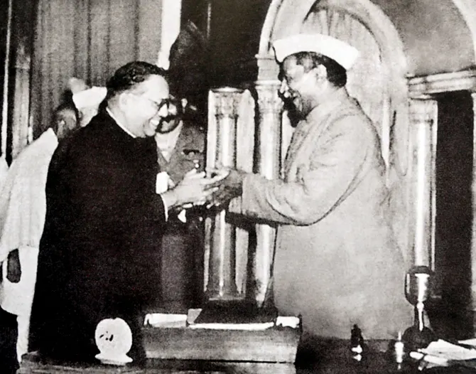 B. R. Ambedkar, chairman of the drafting committee, presents the final draft of the constitution to Rajendra Prasad, 25 November 1949.