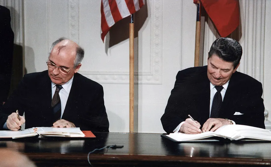 Mikhail Gorbachev and Ronald Reagan sign the INF Treaty in the East Room of the White House, 8 December 1987.