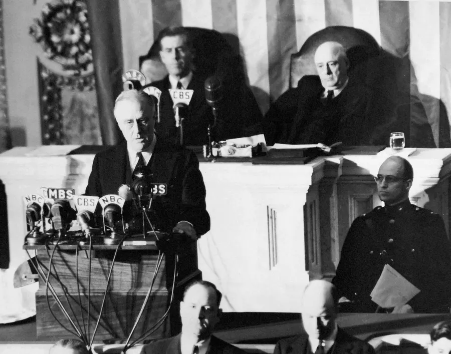 Franklin D. Roosevelt addresses Congress on 8 December 1941, with Vice President Henry Wallace and Speaker Sam Rayburn behind him.