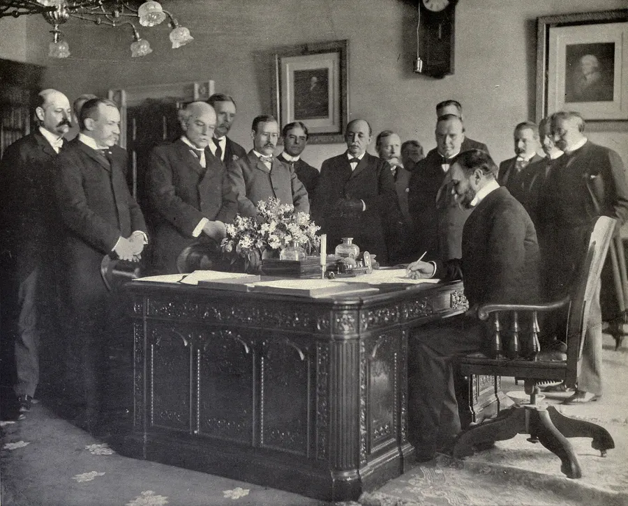 Secretary of State John Hay signs the memorandum of ratification in Washington, 1899, photographed by Frances Benjamin Johnston.