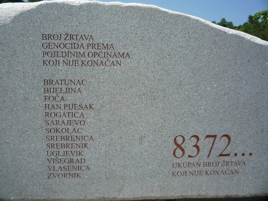 The memorial stone at Potočari, which gives the number of victims as 8,372 and notes that the count is not final