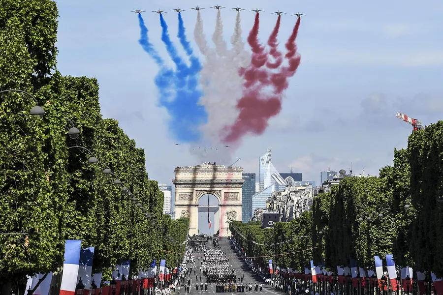 The Patrouille de France trail the colours of the French flag over the Champs-Élysées during the Bastille Day parade in 2017