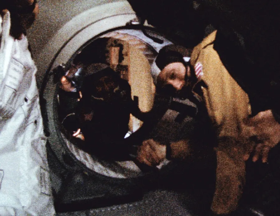 Thomas Stafford and Alexei Leonov meet in the hatchway between Apollo and Soyuz, July 1975