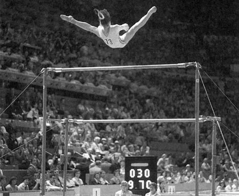 Nadia Comăneci in flight above the uneven bars at the Montreal Olympics in 1976