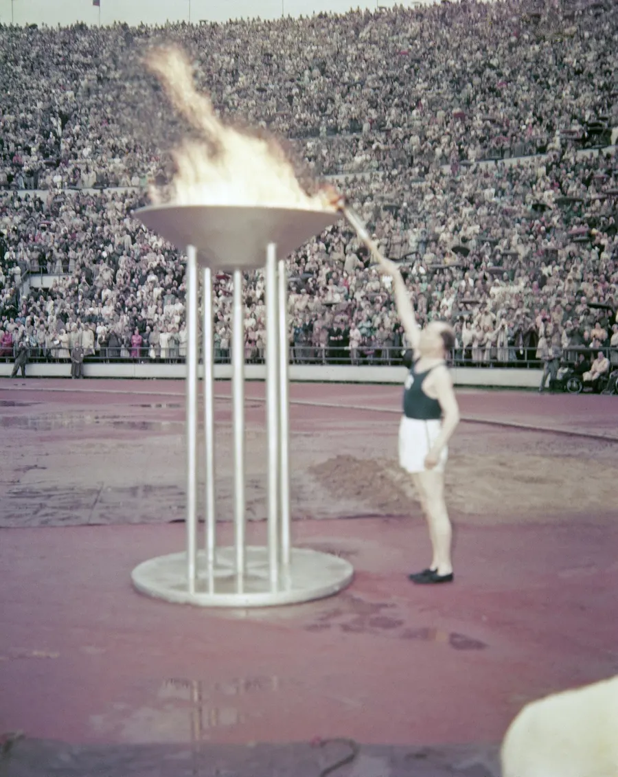 Paavo Nurmi lights the cauldron on the track of the Olympic Stadium at the opening of the Helsinki Games in 1952