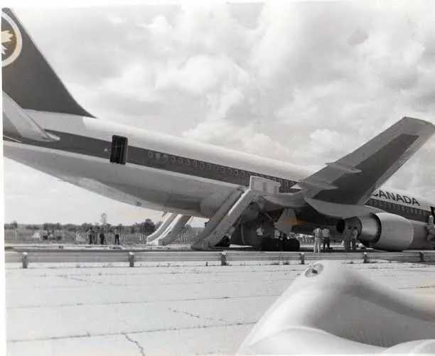 Air Canada Flight 143 on the old runway at Gimli, Manitoba, resting nose-down after its emergency landing, with its escape slides out
