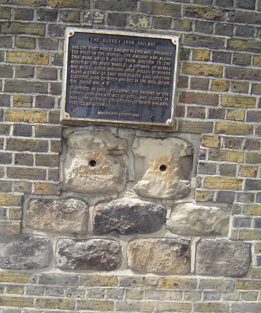 Original stone sleepers from the Surrey Iron Railway, set beneath a plaque in the wall of the former Young's brewery in Wandsworth