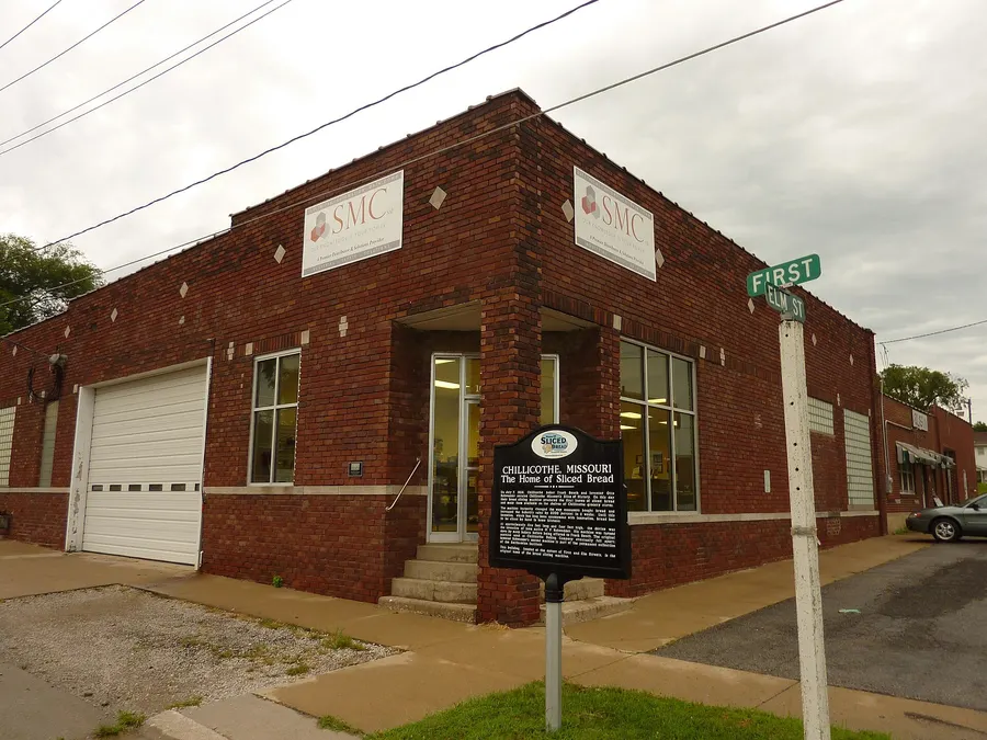 A historical marker in Chillicothe, Missouri, beside the building where the town's bakery first sold machine-sliced bread