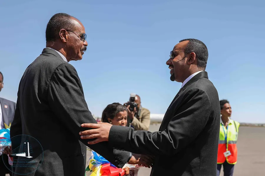 Eritrea's President Isaias Afwerki (left) and Ethiopia's Prime Minister Abiy Ahmed greet each other on an airport apron, in a photograph from the Ethiopian prime minister's office