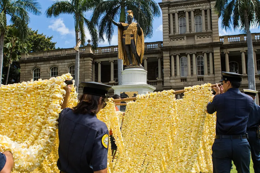 Long lei are carried to the statue of King Kamehameha I in Honolulu for the Kamehameha Day lei-draping ceremony