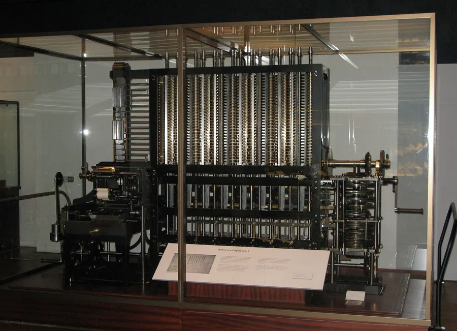 A Babbage Difference Engine on display in a glass case at the Science Museum, London