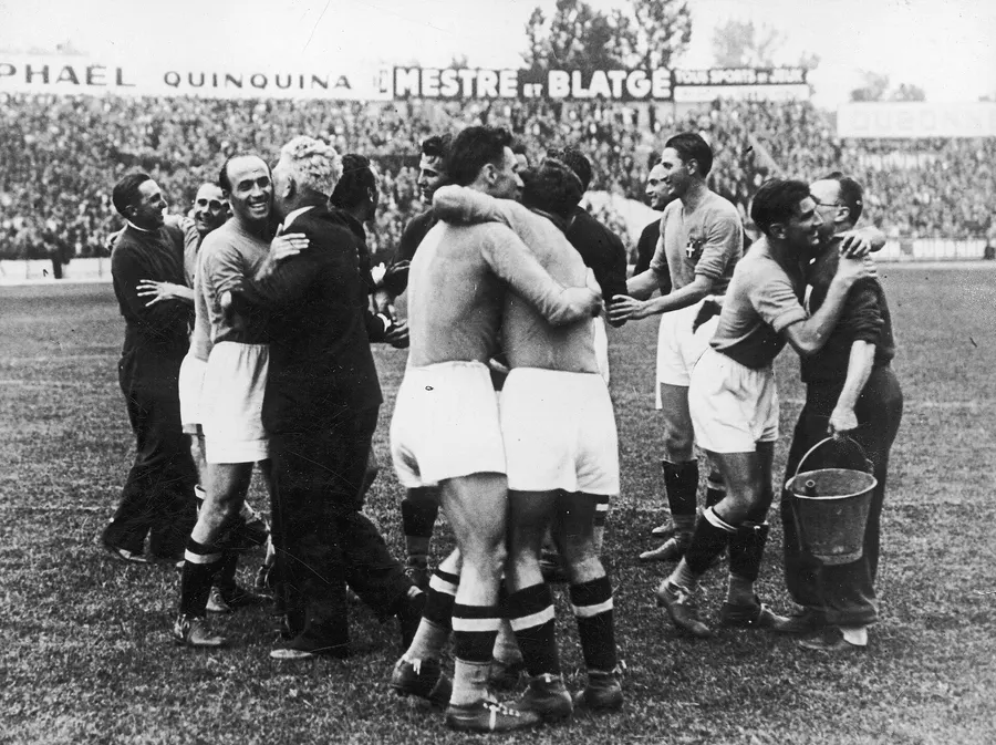 Italy's players celebrate their win over Hungary in the World Cup final at the Stade Olympique de Colombes, Paris, 19 June 1938