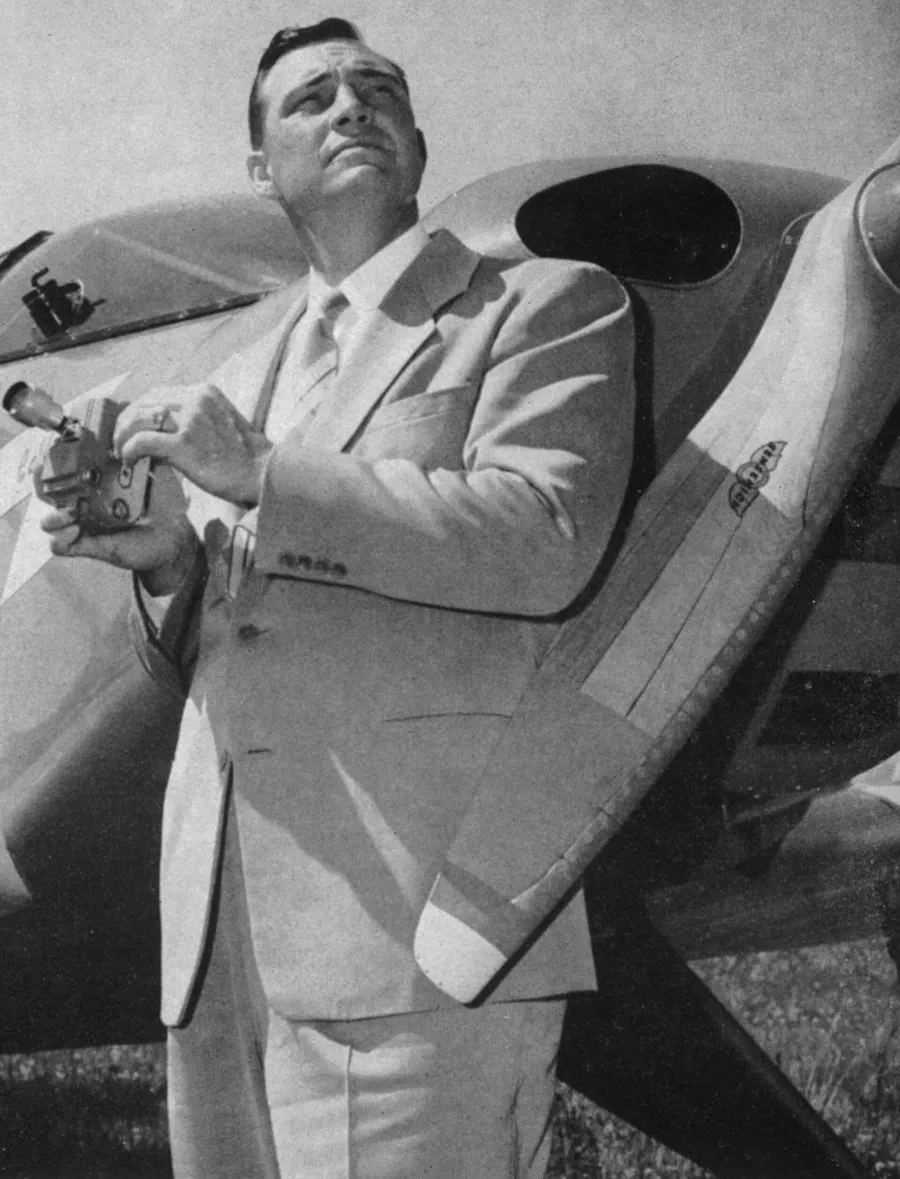 Kenneth Arnold with a camera beside a light aircraft, in an Associated Press photograph