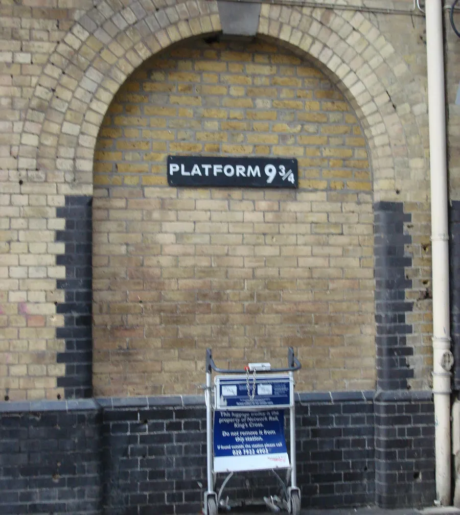 A 'Platform 9¾' sign on a wall at King's Cross station in London, a nod to the books