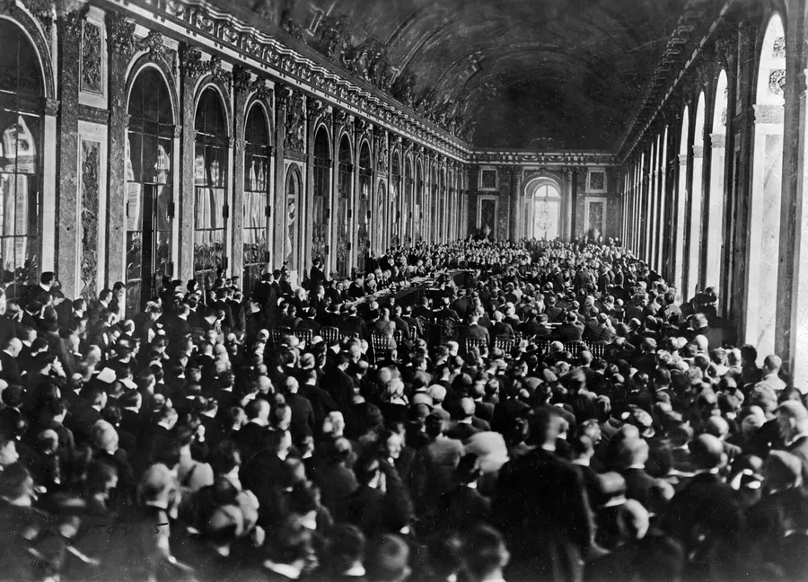 Delegates and guests crowd the Hall of Mirrors at Versailles for the signing of the treaty on 28 June 1919
