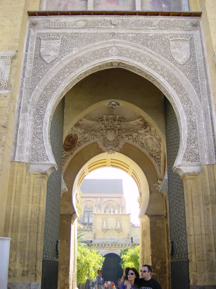 A carved horseshoe arch in the Mosque–Cathedral of Córdoba, looking out towards the later Christian building