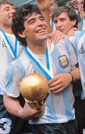 Diego Maradona holds the World Cup trophy as Argentina celebrate in 1986