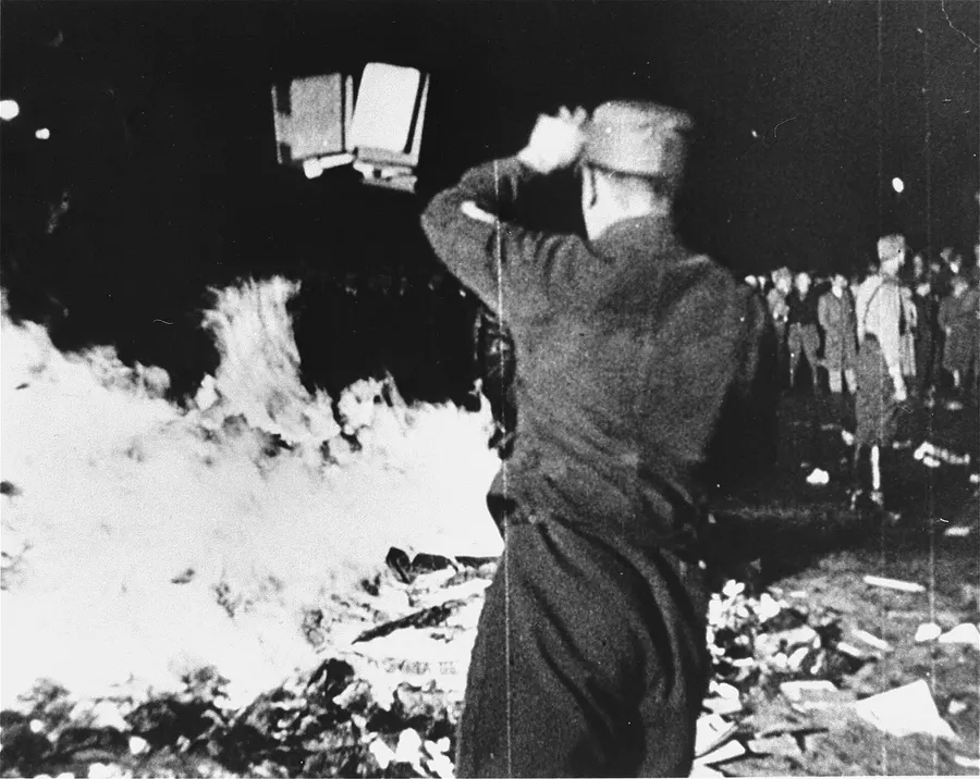 A man throws books onto the fire on Berlin's Opernplatz, 10 May 1933.