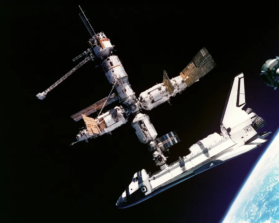 The space shuttle Atlantis docked to the Mir space station, photographed by the Mir-19 crew from their Soyuz in July 1995