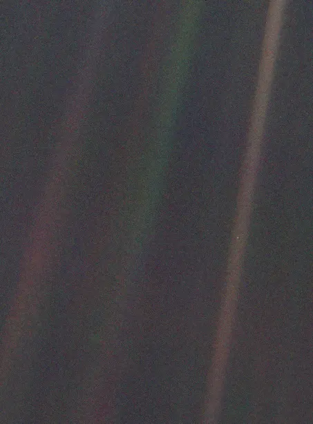 The Pale Blue Dot: Earth, less than a pixel across, in a band of scattered sunlight, photographed by Voyager 1 on 14 February 1990.